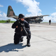 A Taiwanese soldier secures the perimeter of an C-130 transport plane during a search-and-rescue exercise off Taiping island, in the South China Sea , Tuesday, Nov. 29, 2016, as part of efforts to cement its claim to a key island in the strategically vital waterbody. (AP Photo/Johnson Lai)